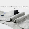 Side profile of gray crew socks highlighting a secure fit, high-quality material, and stylish design.