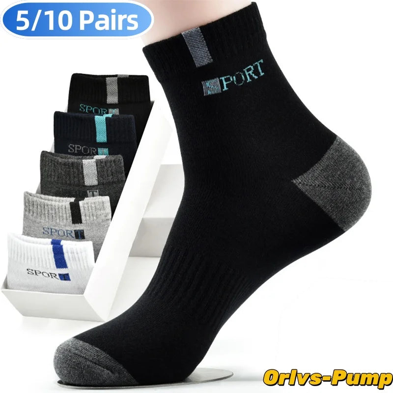A stack of black, gray, and white men's crew socks with a bamboo fiber blend for comfort and breathability