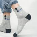 A person wearing black crew socks, demonstrating their stylish and snug fit.