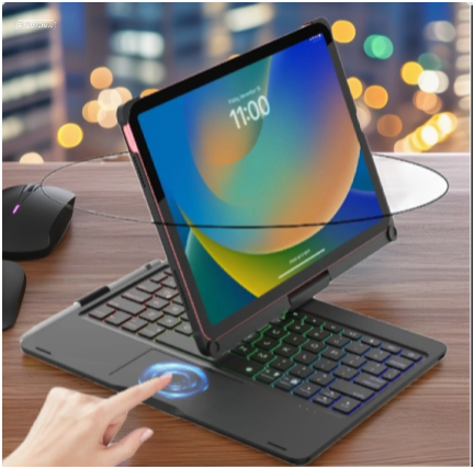 Touchpad-enabled wireless iPad keyboard with RGB backlighting, shown in a modern high-rise office setting with city lights glowing through the window.